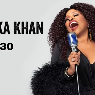 chaka khan singing into a microphone