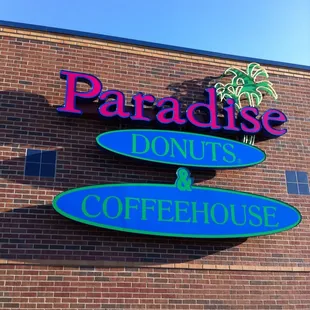 a sign for paradise donuts and coffeehouse