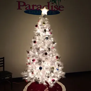 a white christmas tree with ornaments