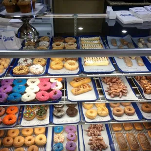 a variety of doughnuts in a display case