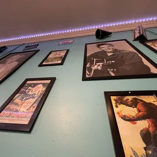 a blue wall with framed pictures
