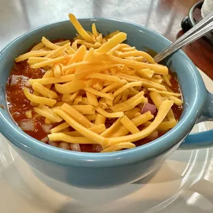 Bowl of Chili with Onions and Cheese