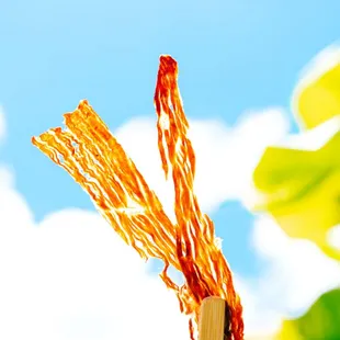 a piece of food sticking out of a stick