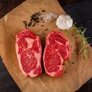 two steaks on a cutting board