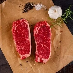 two steaks on a cutting board