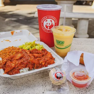 a tray of food and a drink on a table