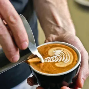 a bari serving a cup of coffee