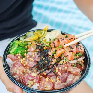 a person holding a bowl of food