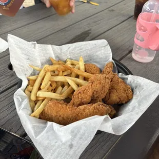 a basket of fried chicken and french fries