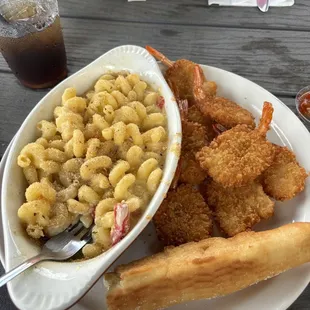 a bowl of macaroni and cheese with a side of fried shrimp