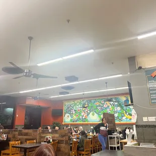 a woman sitting at a table with a laptop