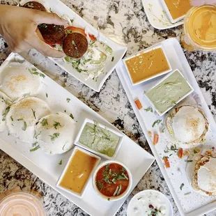 New idli egg sandwiches, idli, sambar, chutneys (coconut and tomato), and curry falafel balls. 11/10!