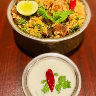 a bowl of birya rice and a bowl of yogurt