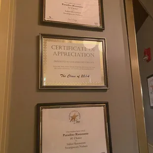 three certificates on a wall