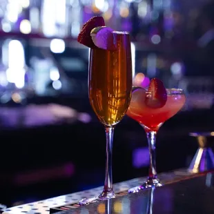 two cocktails on a bar