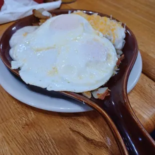 a plate of eggs and hash browns