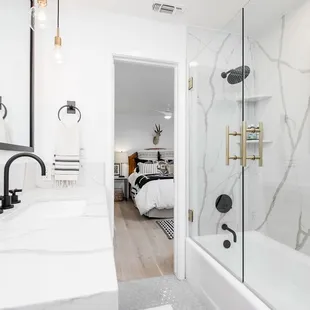 a bathroom with a shower, sink, and bathtub