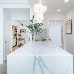 a kitchen island with a marble countertop