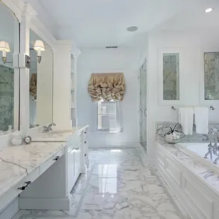 a large bathroom with marble countertops
