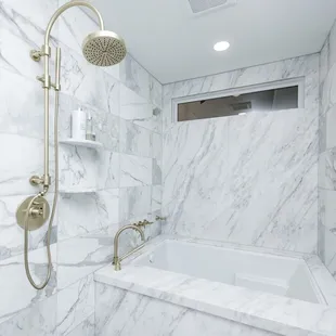 a bathroom with a shower and tub