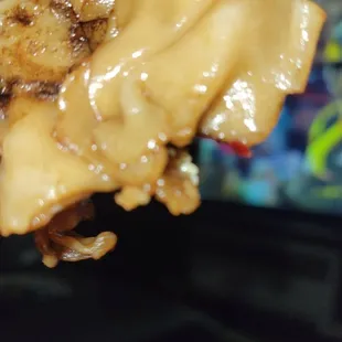a hand holding a piece of food