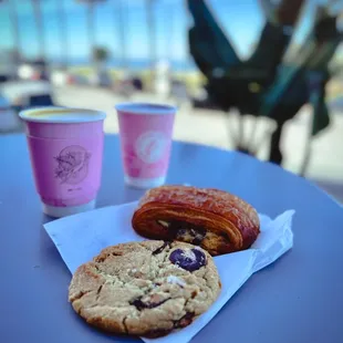 a croissant and a cookie on a table