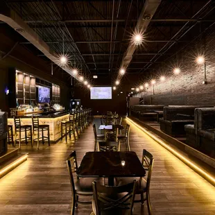 a restaurant with a long table and chairs