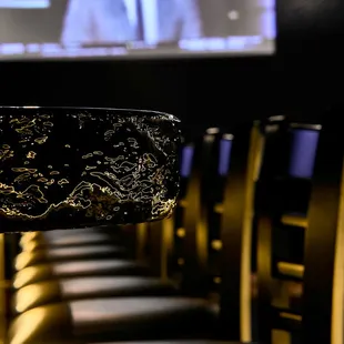 a man in a suit and tie on a screen in the background