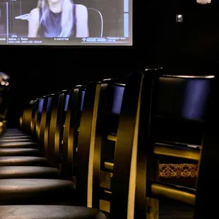 a row of chairs in front of a television