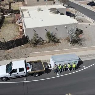 The Paramount team posed with their equipment, ready to apply a silicone roof coating.
