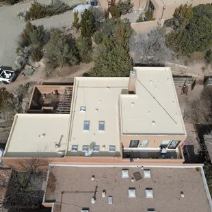 Bird&apos;s-eye view of a charming Albuquerque bungalow and its newly coated silicone roof.