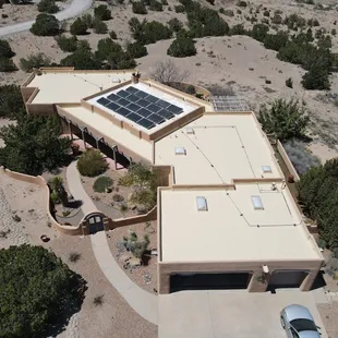 A completed Paramount silicone roof coating project, glistening under the clear Albuquerque sky.