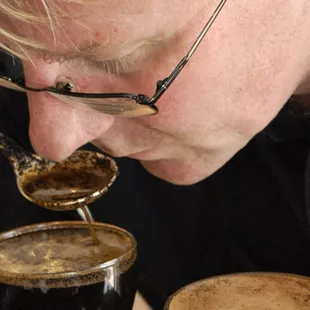 a man eating a cup of coffee