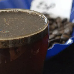 a cup of coffee and a bag of coffee beans