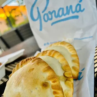 three empanadas on a table