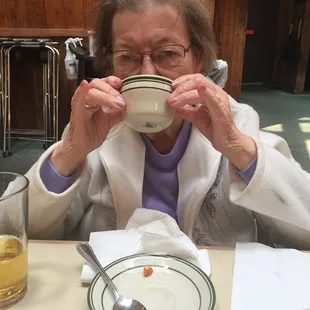 Mom demonstrating the correct way to eat Italian wedding soup.