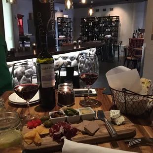 a table with wine and cheese