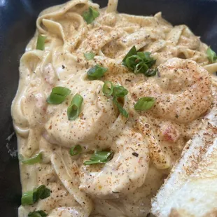 Seafood Cajun Pasta - Sautéed Shrimp and crawfish tails cooked in Creamy Cajun Alfredo Sauce and Texas toast