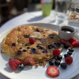 Pancake with blueberries, polenta, walnut cinnamon butter, and warm maple syrup