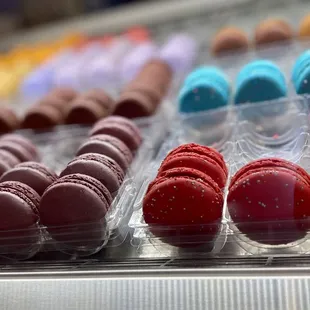 a variety of macarons in a display case