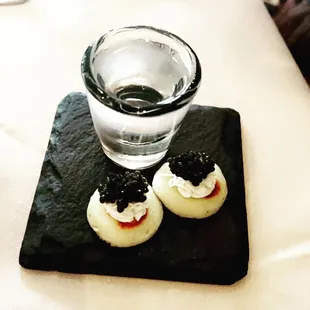 a glass of water and a small dessert