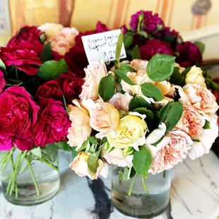 two vases of flowers on a marble table