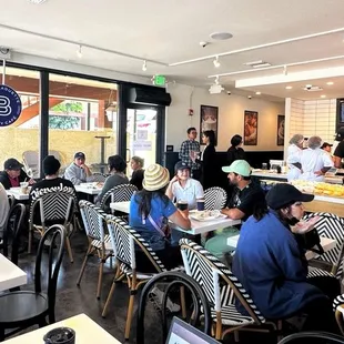 people sitting at tables in a cafe