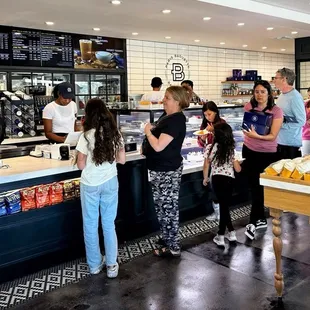 a group of people in a bakery