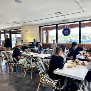 people sitting at tables in a cafe