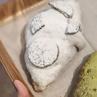 a hand holding a pastry