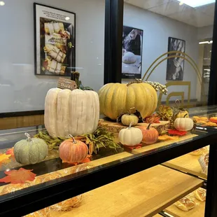 a display of pumpkins and leaves