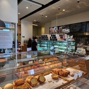 a bakery counter with a variety of pastries