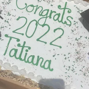 a large sheet cake with congratulationss written on it