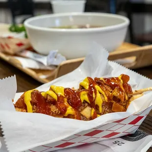 a hotdog with mustard and ketchup